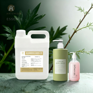 Hand pouring herbal mugwort scented body wash into a wooden bath scoop creating relaxing foam